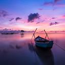 Boat on the water, purple evening sky